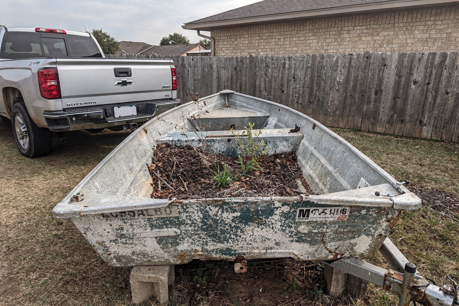 Junk boat removal Oklahoma City backyard aluminum jon boat disposal