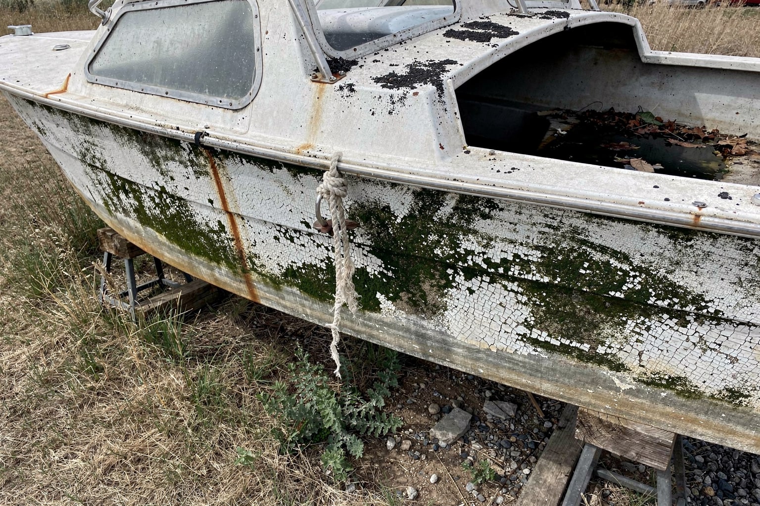 Junk boat hull deterioration showing boat disposal condition in South Dakota