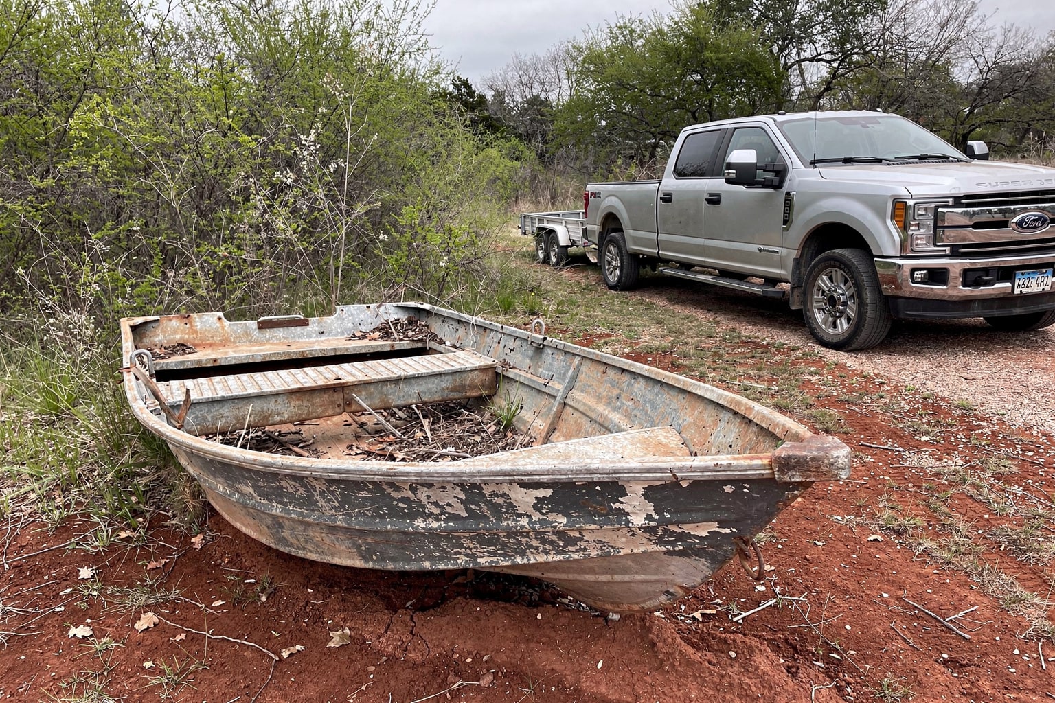 Abandoned junk boat disposal Texas overgrown yard salvage removal