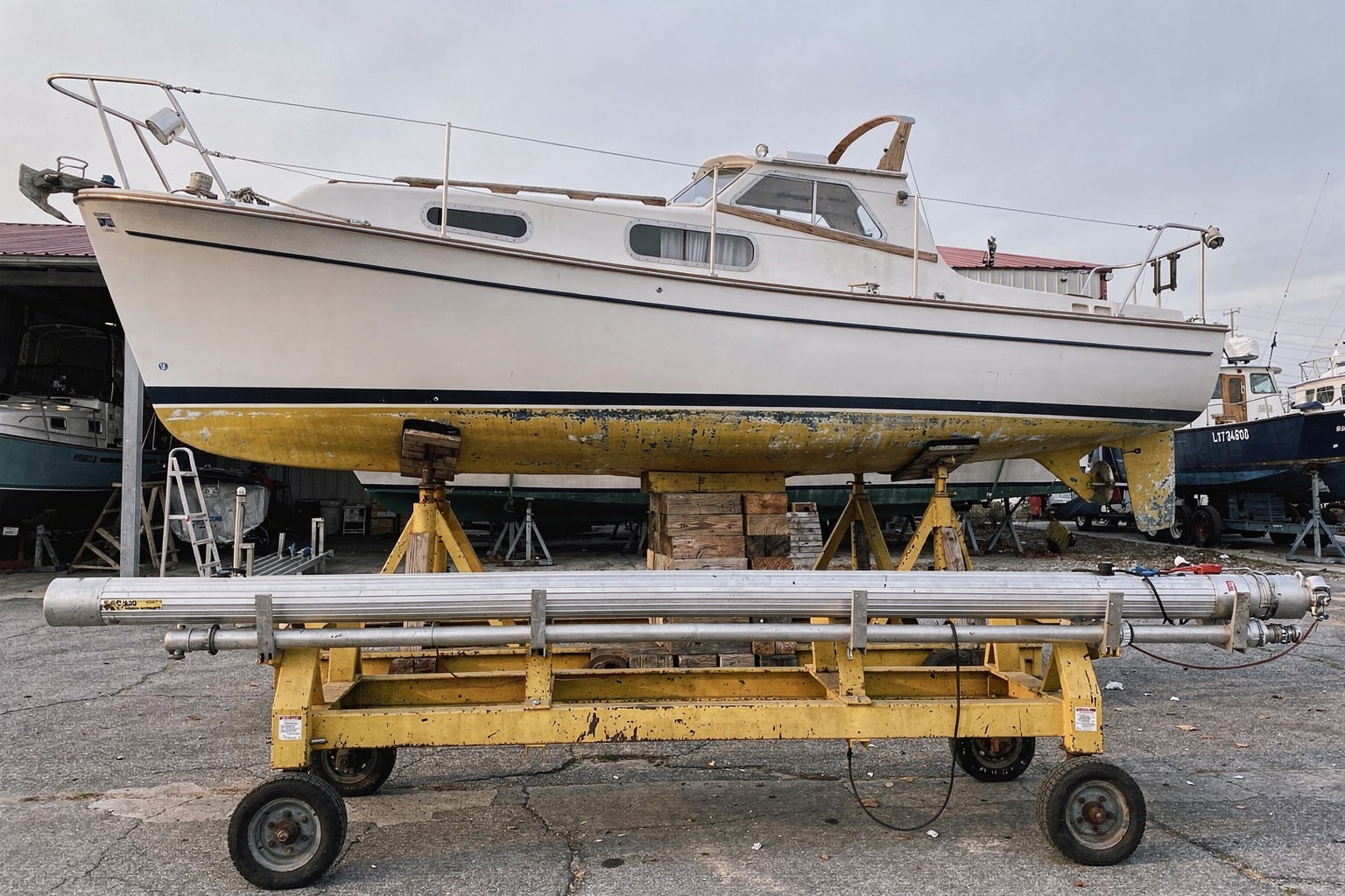 26-foot sailboat on steel cradle at Virginia Beach boatyard for removal and disposal