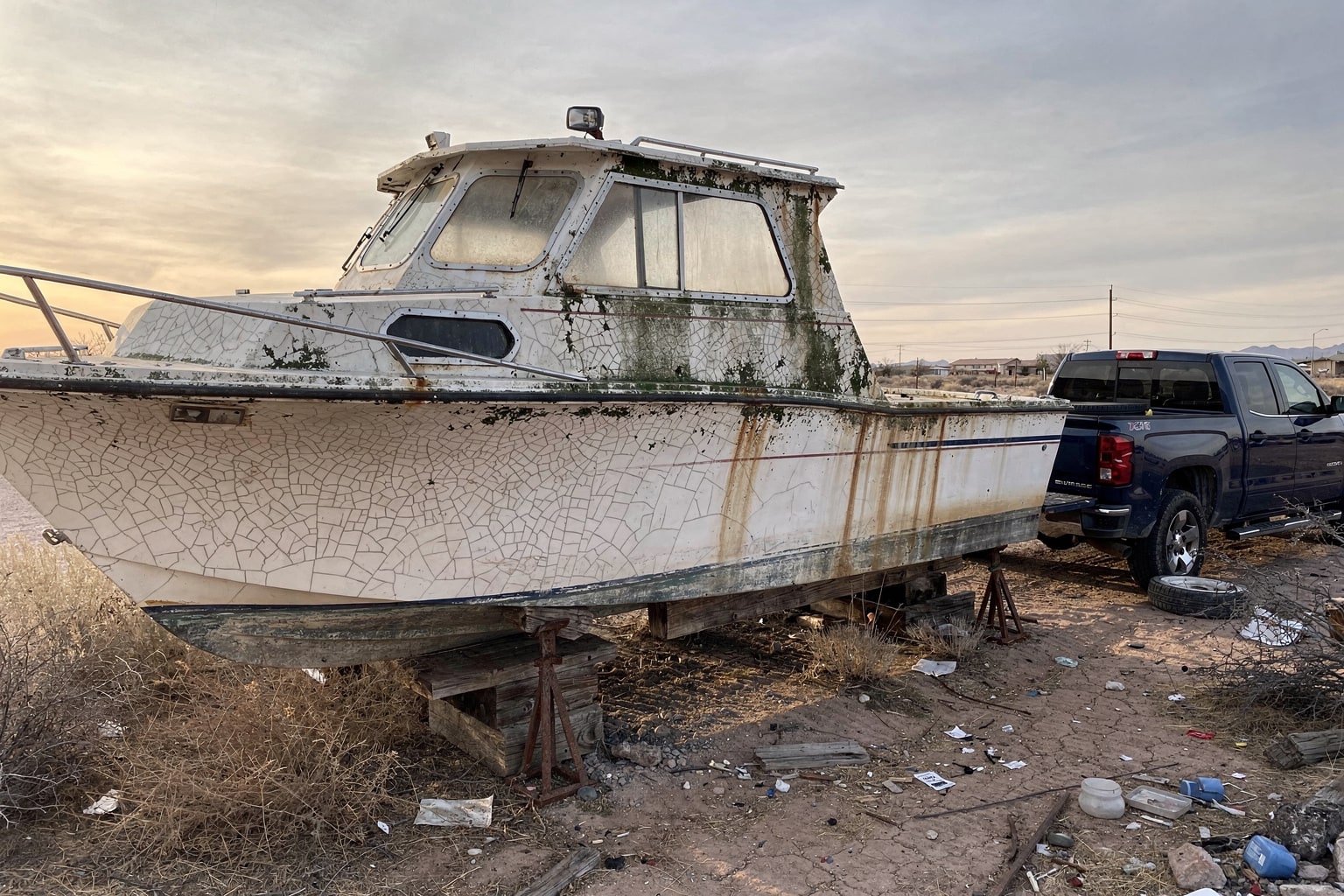 Deteriorated fiberglass powerboat junk boat disposal marine salvage desert Arizona property