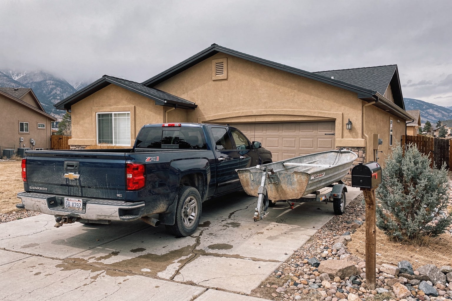 Junk boat removal in Aurora Colorado driveway with pickup truck and trailer
