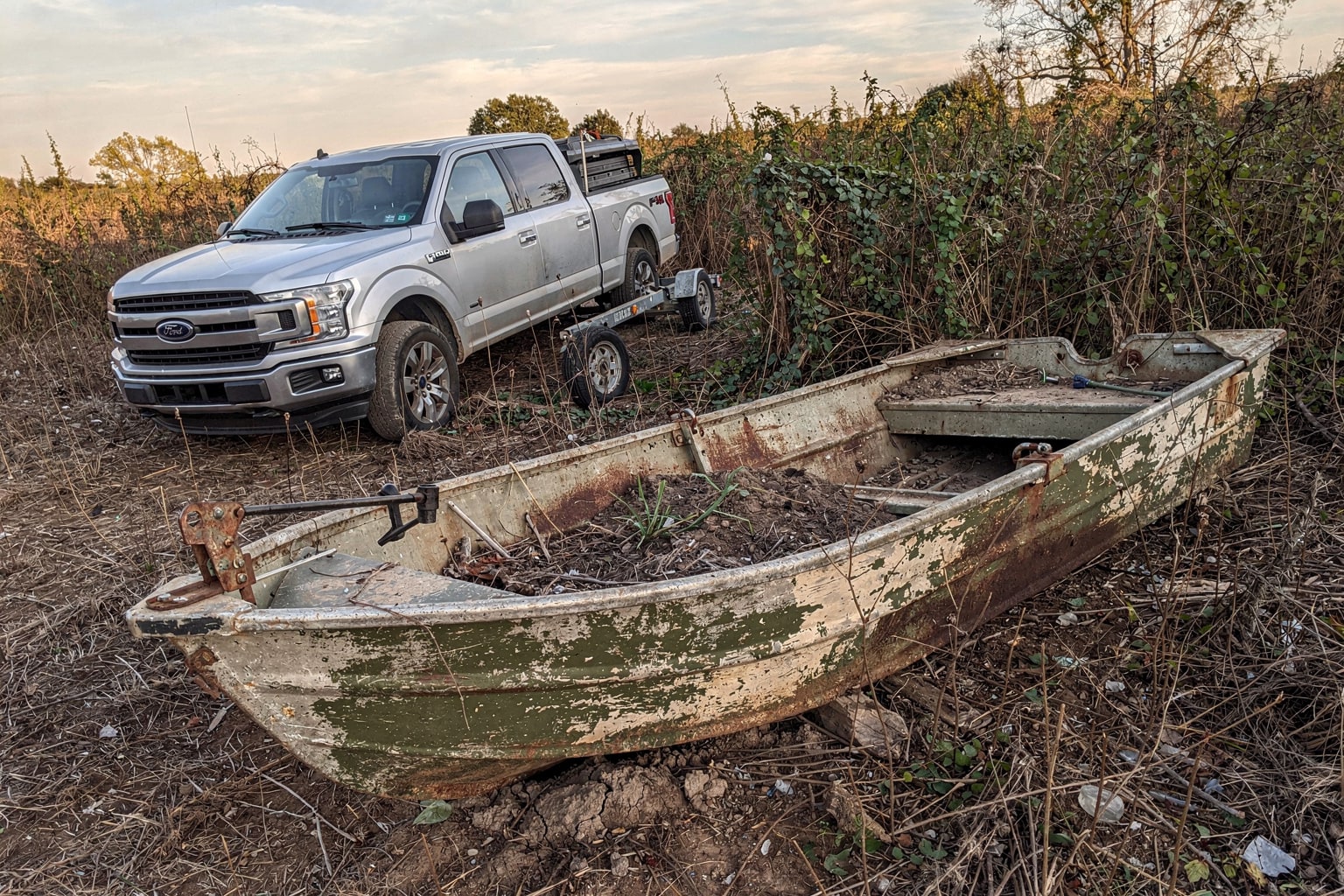 Junk boat removal Dallas Texas abandoned deteriorated jon boat overgrown property disposal