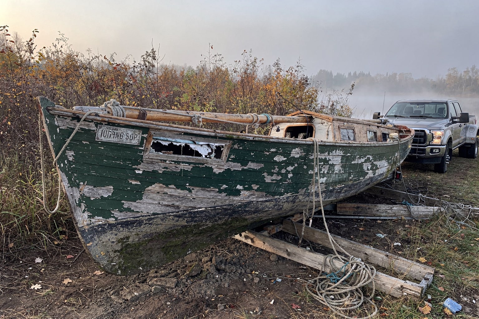 Derelict sailboat salvage removal, abandoned Minnesota property, overgrown weeds and neglected shed