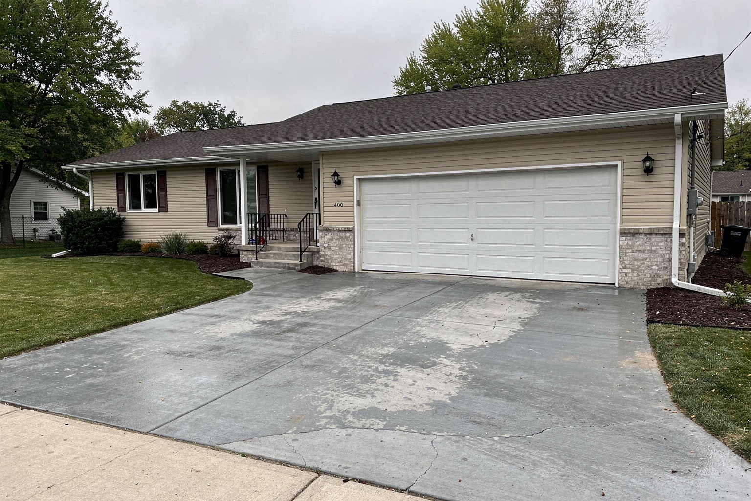 Boat removal completed Omaha Nebraska: clean residential driveway after junk boat disposal by Hansons professional service