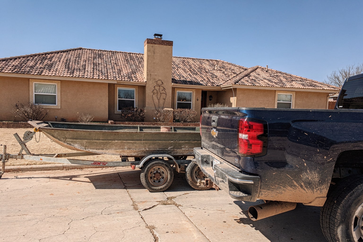 Junk boat removal in Texas on trailer, pickup truck ready for hauling