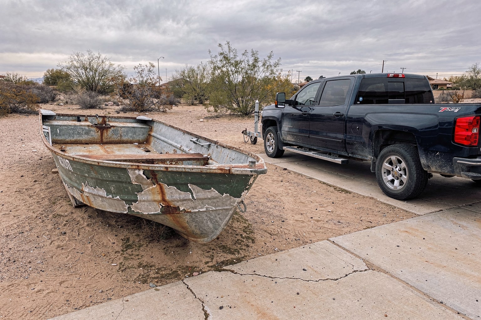 Abandoned junk boat removal from overgrown Tucson desert yard, disposal service ready