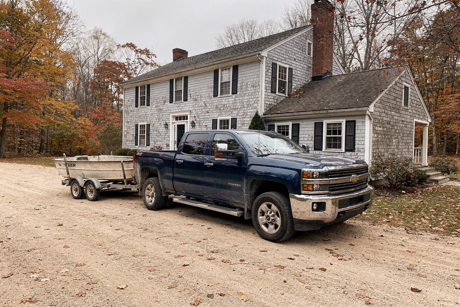 Weathered 16-foot fishing boat on trailer ready for removal at Vermont home