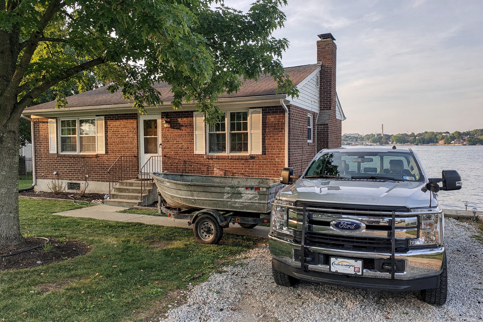Deteriorated aluminum fishing boat removal on trailer, Washington DC residential property with pickup truck