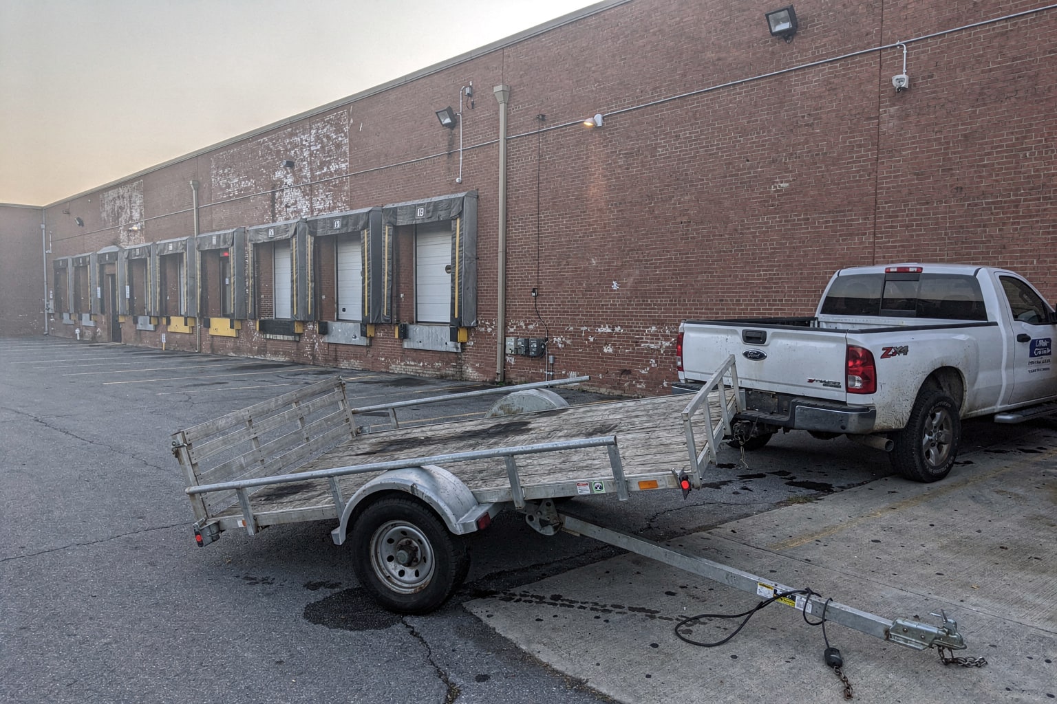 Deteriorated jon boat removal at Washington DC commercial warehouse loading dock area