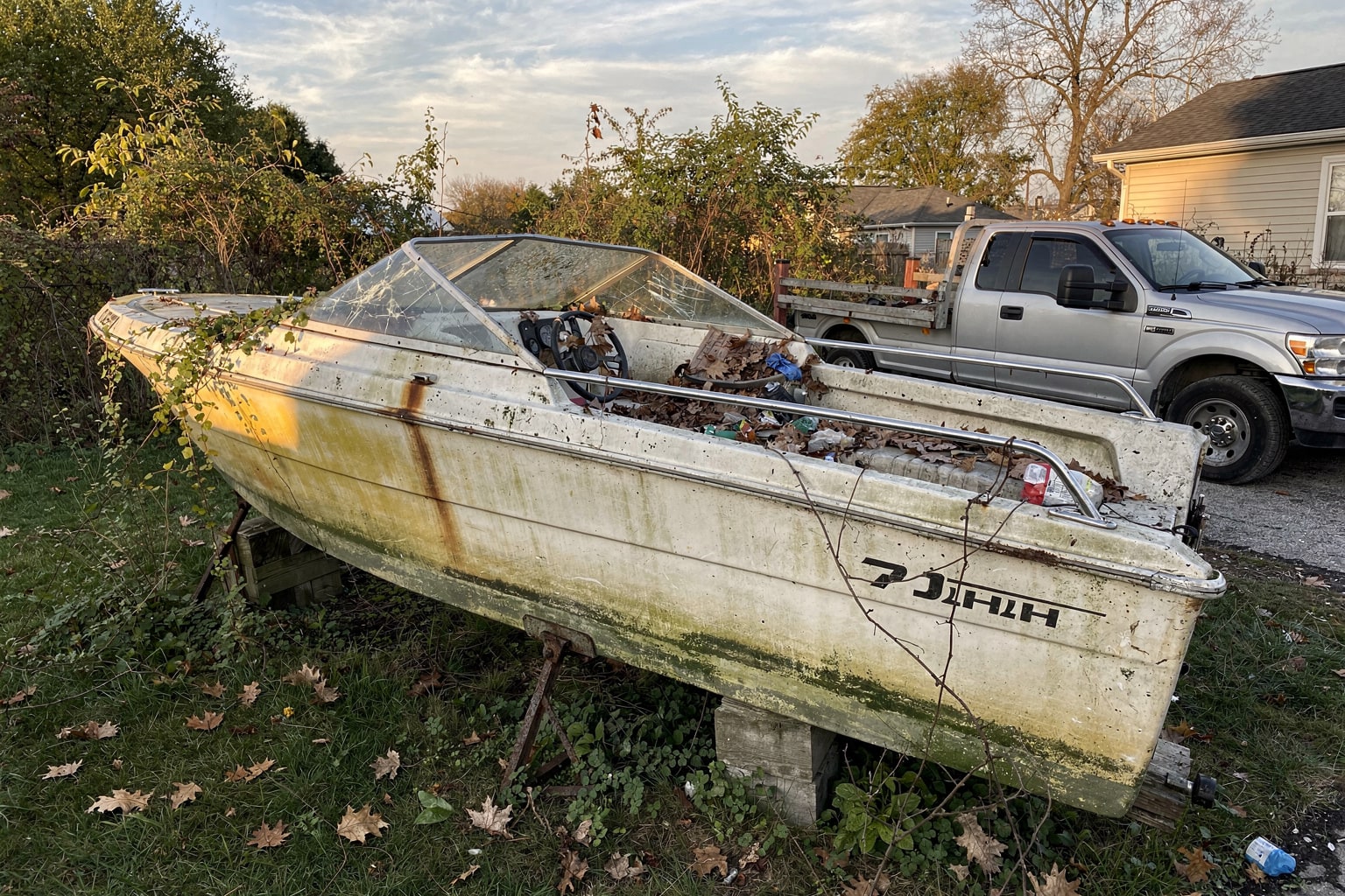 Abandoned junk boat removal Columbus Ohio overgrown yard disposal service