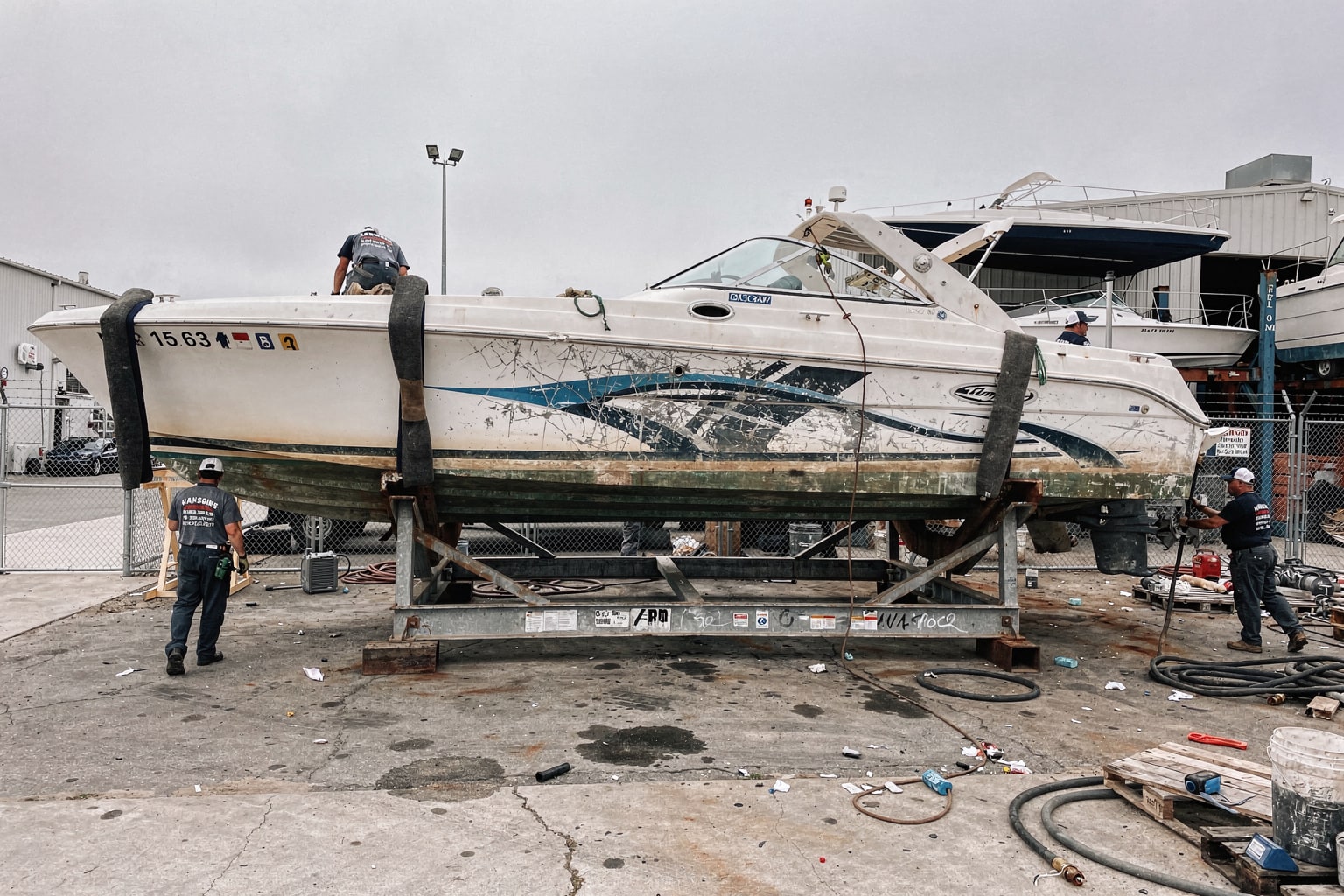 Junk boat removal at Long Beach boatyard showing multiple boats awaiting disposal and dismantling