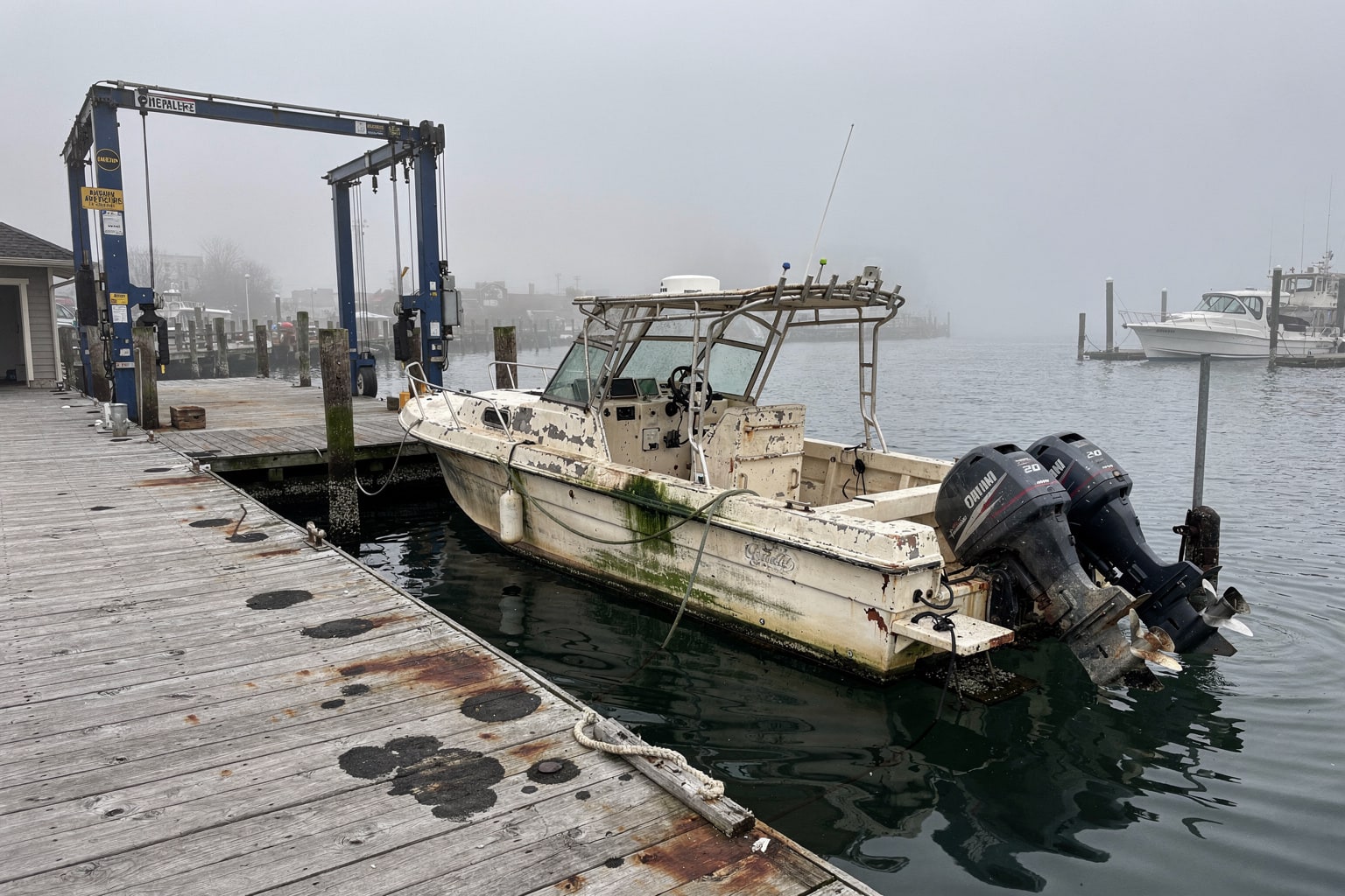 Junk boat removal Staten Island NY waterfront marina with travel-lift disposal operation